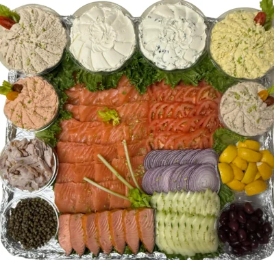 Smoked fish platter with lox, salmon, white fish, tuna, and cream cheese.